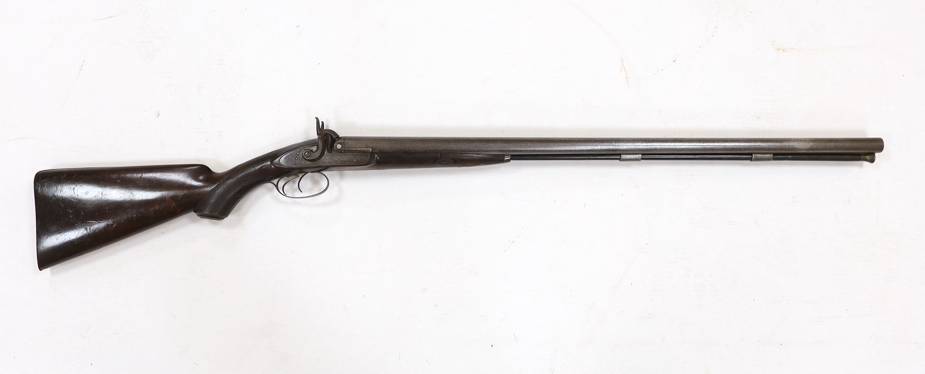 A double barrel, percussion sporting gun by F.T. Baker, half stocked, locks engraved with gundogs, iron mounts, barrels 74cm